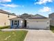 Charming single-story home featuring stone accents, a two-car garage, and a welcoming front porch at 2934 Living Coral Dr, Odessa, FL 33556
