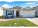 Charming single-Gathering home with stone accents, two-car garage and inviting front porch at 2934 Living Coral Dr, Odessa, FL 33556