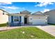 Attractive house with stone accents, a two-car garage, and a welcoming front yard at 2934 Living Coral Dr, Odessa, FL 33556
