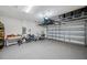 Spacious garage with epoxy flooring, overhead racks, and ample space for storage and recreation at 2934 Living Coral Dr, Odessa, FL 33556