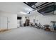 Well-lit garage features overhead storage racks, epoxy floor, and a side door at 2934 Living Coral Dr, Odessa, FL 33556