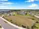 Aerial view of a large, open park area with soccer net, landscaping, and trails at 2934 Living Coral Dr, Odessa, FL 33556