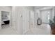 Hallway view showcasing the doorways leading to a bedroom and the front entryway at 2934 Living Coral Dr, Odessa, FL 33556