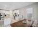 Bright kitchen and dining area with white cabinets, granite countertops, and stainless steel appliances at 2934 Living Coral Dr, Odessa, FL 33556