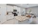 Modern kitchen features stainless steel appliances, granite countertops, and an island with a sink at 2934 Living Coral Dr, Odessa, FL 33556