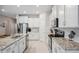 Modern kitchen featuring white cabinets, stainless steel appliances, and granite countertops at 2934 Living Coral Dr, Odessa, FL 33556