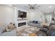 Bright living room with a fireplace, a large TV, and cozy seating, creating a welcoming atmosphere at 2934 Living Coral Dr, Odessa, FL 33556