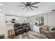 Open-concept living room features a modern ceiling fan and sliding doors to a screened lanai at 2934 Living Coral Dr, Odessa, FL 33556