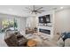 Cozy living room featuring a fireplace, tv, and comfortable seating, perfect for relaxation at 2934 Living Coral Dr, Odessa, FL 33556