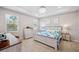 Main bedroom featuring a tray ceiling, bright windows, neutral walls and light colored wood furnishings at 2934 Living Coral Dr, Odessa, FL 33556