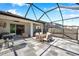 Expansive screened-in patio with dining area, outdoor seating, grill, and access to the home at 2934 Living Coral Dr, Odessa, FL 33556