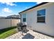 Back patio area featuring a small grill and exterior view of the home at 2934 Living Coral Dr, Odessa, FL 33556