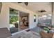 Beautiful, covered patio with ceiling fans, comfortable seating, and view into the kitchen and dining area at 2934 Living Coral Dr, Odessa, FL 33556