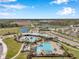 Aerial view of community pools, palm trees, and landscaping in a Gathering-friendly neighborhood at 2934 Living Coral Dr, Odessa, FL 33556