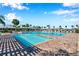 A large community pool featuring multiple entrances surrounded by palm trees at 2934 Living Coral Dr, Odessa, FL 33556