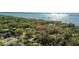Aerial view of a home nestled among lush greenery near a glistening body of water at 3010 82Nd N Way, St Petersburg, FL 33710
