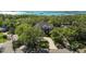 A beautiful home surrounded by trees with a brick driveway, near a large body of water at 3010 82Nd N Way, St Petersburg, FL 33710