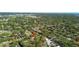 Wide aerial view of a property in a dense residential area filled with lots of mature trees at 3010 82Nd N Way, St Petersburg, FL 33710
