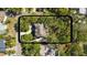 Aerial shot showcasing a home with mature trees and greenery at 3010 82Nd N Way, St Petersburg, FL 33710