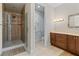 Bathroom featuring a walk-in shower with glass door and vanity with marble countertop at 3010 82Nd N Way, St Petersburg, FL 33710