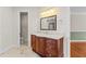 Bathroom featuring a vanity with a beautiful mirror and a doorway to a walk in closet at 3010 82Nd N Way, St Petersburg, FL 33710