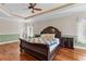 Spacious bedroom with wood floors, ceiling fan and a door leading to the outside at 3010 82Nd N Way, St Petersburg, FL 33710