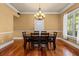 Charming dining room featuring hardwood floors, elegant chandelier, and natural light from a nearby window at 3010 82Nd N Way, St Petersburg, FL 33710
