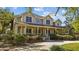Inviting two-story home boasting a charming front porch and well-manicured landscaping at 3010 82Nd N Way, St Petersburg, FL 33710