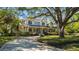 Traditional home with an inviting front porch, long driveway, and established landscaping at 3010 82Nd N Way, St Petersburg, FL 33710