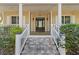 Inviting front porch with elegant columns and decorative lighting on the staircase at 3010 82Nd N Way, St Petersburg, FL 33710