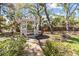 Charming white gazebo surrounded by lush greenery and a brick pathway at 3010 82Nd N Way, St Petersburg, FL 33710
