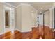 Spacious hallway with hardwood floors and views into bedroom and bathroom at 3010 82Nd N Way, St Petersburg, FL 33710