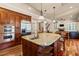 Spacious kitchen with large center island, wood cabinetry, stainless steel appliances, open to the living room at 3010 82Nd N Way, St Petersburg, FL 33710