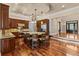 Open-concept kitchen boasts a large island with seating, wood cabinets, and stainless steel appliances at 3010 82Nd N Way, St Petersburg, FL 33710