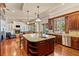 Large kitchen features a center island with seating, stainless steel appliances, and wood cabinets at 3010 82Nd N Way, St Petersburg, FL 33710