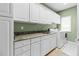 Well-equipped laundry room with ample counter space, built-in cabinets, and modern appliances at 3010 82Nd N Way, St Petersburg, FL 33710