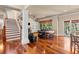 Open-concept living room with hardwood floors, staircase, fireplace and large windows to outdoors at 3010 82Nd N Way, St Petersburg, FL 33710