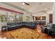 Open-concept living room featuring hardwood floors, a comfortable sectional sofa, and scenic outdoor views at 3010 82Nd N Way, St Petersburg, FL 33710