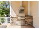 Outdoor kitchen with built-in grill and stone accents, perfect for alfresco dining and entertaining guests at 3010 82Nd N Way, St Petersburg, FL 33710