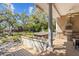Covered deck with a hot tub, outdoor grill, and lush greenery, offering a tranquil retreat and outdoor cooking at 3010 82Nd N Way, St Petersburg, FL 33710