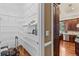 Walk-in pantry with metal shelving provides ample storage space, complemented by the adjacent kitchen at 3010 82Nd N Way, St Petersburg, FL 33710