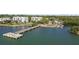 Scenic aerial showing pier and boat ramp alongside a waterfront community with lush greenery at 3010 82Nd N Way, St Petersburg, FL 33710
