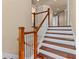 Wooden staircase with white risers and elegant banister design at 3010 82Nd N Way, St Petersburg, FL 33710