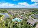 Aerial view of a community pool surrounded by palm trees, lakes and residences at 32101 Goddard Dr, Wesley Chapel, FL 33543