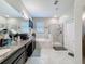 Bright bathroom features a double vanity, soaking tub, glass-enclosed shower, and tile flooring at 32101 Goddard Dr, Wesley Chapel, FL 33543