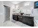 Well-lit bathroom features a double vanity, granite countertops, dark cabinetry, and tile flooring at 32101 Goddard Dr, Wesley Chapel, FL 33543