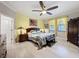 Well-lit bedroom with a large bed, wooden furniture, and ample natural light from the windows at 32101 Goddard Dr, Wesley Chapel, FL 33543