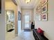 Inviting entryway with decorative tile, decorative glass front door, and charming bench with Gathering photo gallery at 32101 Goddard Dr, Wesley Chapel, FL 33543