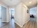 Hallway features wood-look flooring and doorways leading to various rooms, creating a seamless flow at 32101 Goddard Dr, Wesley Chapel, FL 33543