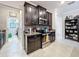 Well-equipped kitchen with dark cabinets, granite countertops, stainless steel appliances, and mosaic tile backsplash at 32101 Goddard Dr, Wesley Chapel, FL 33543
